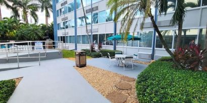 Outdoor garden and terrace at EnVision Hotel Miami International Airport.