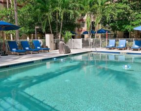 Large outdoor pool with sun lounge chairs at Sonesta ES Suites Fort Lauderdale Plantation.