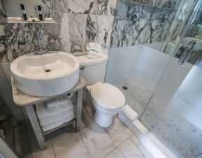 Guest bathroom with shower at Chesterfield Hotel & Suites.