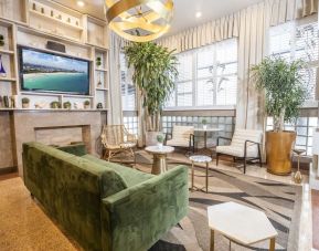 Lobby and lounge area with TV at Chesterfield Hotel & Suites.