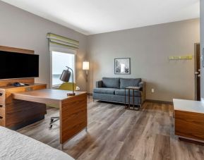 Spacious day use room with TV and lounge at Hampton Inn & Suites By Hilton Edmonton/West.