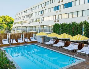Relaxing outdoor pool with pool loungers at Hotel Dena, Pasadena Los Angeles.