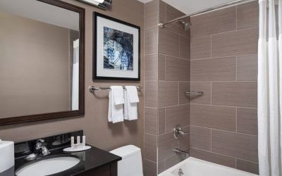 Guest bathroom with shower and bath at Fairfield Inn & Suites By Marriott New York Staten Island.