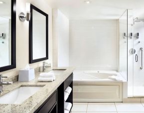 Guest bathroom with shower and bath at Four Points By Sheraton Mississauga Meadowvale.