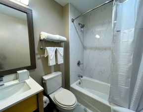 Guest bathroom with shower and bath combo at Days Inn By Wyndham Staten Island.