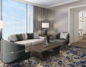 Spacious king room with lounge area at Hilton BNA Nashville Airport Terminal.