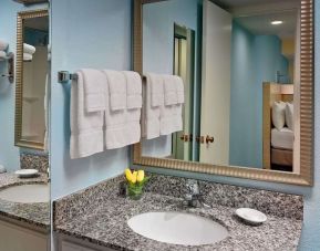 Sonesta ES Suites Tucson guest bathroom provides an ensuite shower and sink.