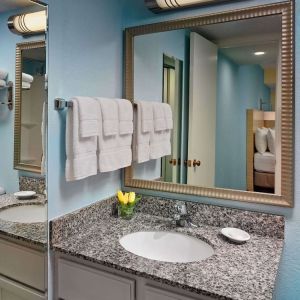 Sonesta ES Suites Tucson guest bathroom provides an ensuite shower and sink.