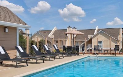 Outdoor pool with pool chairs at Sonesta ES Suites Cincinnati - Blue Ash.