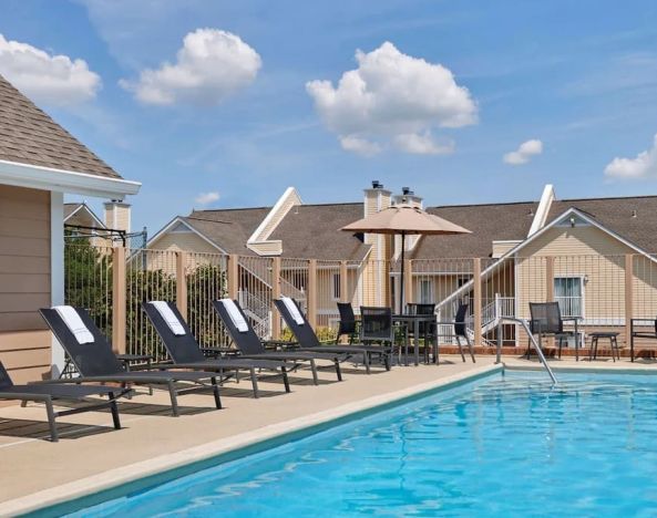 Outdoor pool with pool chairs at Sonesta ES Suites Cincinnati - Blue Ash.