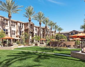 Hotel exterior with garden at Sonesta Suites Scottsdale Gainey Ranch.