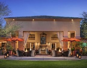 Hotel exterior with outdoor seating at Sonesta Suites Scottsdale Gainey Ranch.