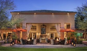 Hotel exterior with outdoor seating at Sonesta Suites Scottsdale Gainey Ranch.