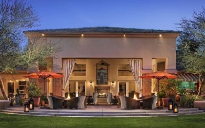 Hotel exterior with outdoor seating at Sonesta Suites Scottsdale Gainey Ranch.