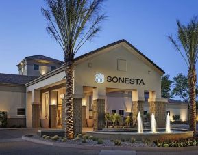Hotel exterior and parking at Sonesta Suites Scottsdale Gainey Ranch.
