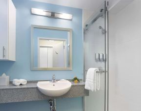 Guest bathroom with shower at Sonesta ES Suites New Orleans.