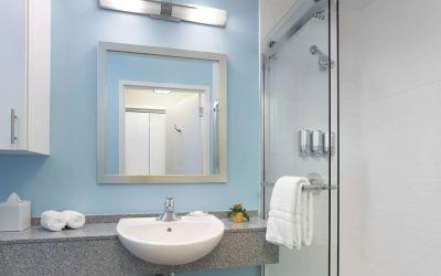Guest bathroom with shower at Sonesta ES Suites New Orleans.