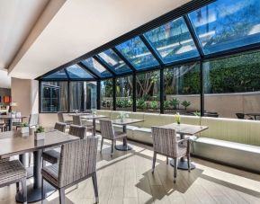 Dining area with natural light at Sonesta Los Angeles Airport LAX.