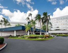 Parking and hotel exterior at Sonesta Miami Airport.