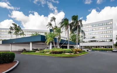Parking and hotel exterior at Sonesta Miami Airport.