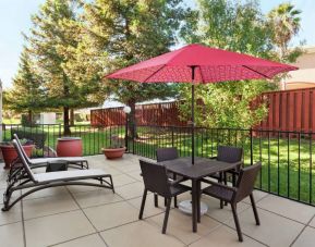 Outdoor garden and terrace at Hampton Inn Tracy.