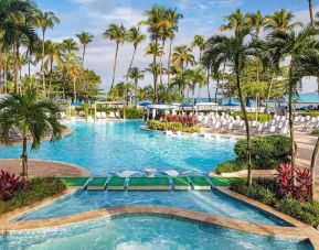 Outdoor pool with palm trees at Royal Sonesta San Juan.