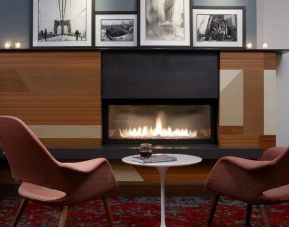 Cozy lounge with fire place at The Fifty Sonesta Select New York.