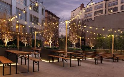 Outdoor lounge with night lights at The Tillary Hotel.