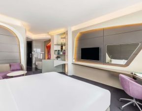 Well-lit king room at V Hotel Dubai.