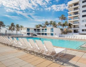 Outdoor pool and palm trees at New Point Miami.