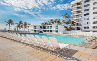 Outdoor pool and palm trees at New Point Miami.