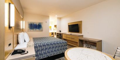 Day use room with TV and work desk at Palace Inn Blue IAH East.