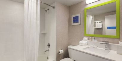Guest bathroom with shower and tub at Hampton Inn & Suites Ft. Lauderdale Airport/South Cruise Port.