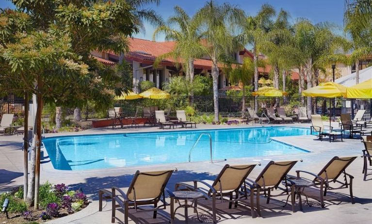 Outdoor pool with pool loungers at DoubleTree By Hilton Ontario Airport.