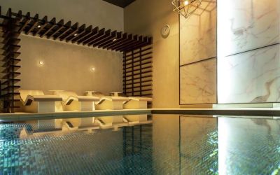 Indoor pool with chair loungers at Hilton Aberdeen TECA.