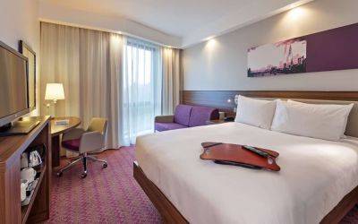 King bed with work desk at Hampton By Hilton London Gatwick Airport.