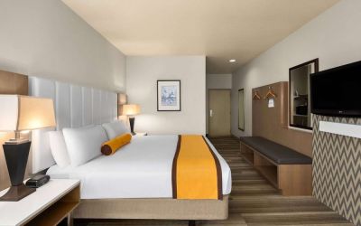 King bed with TV at Hotel Marguerite.