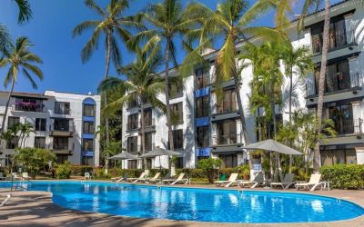 Stunning outdoor pool with palm trees at Puerto De Luna Pet Friendly & Family Suites.