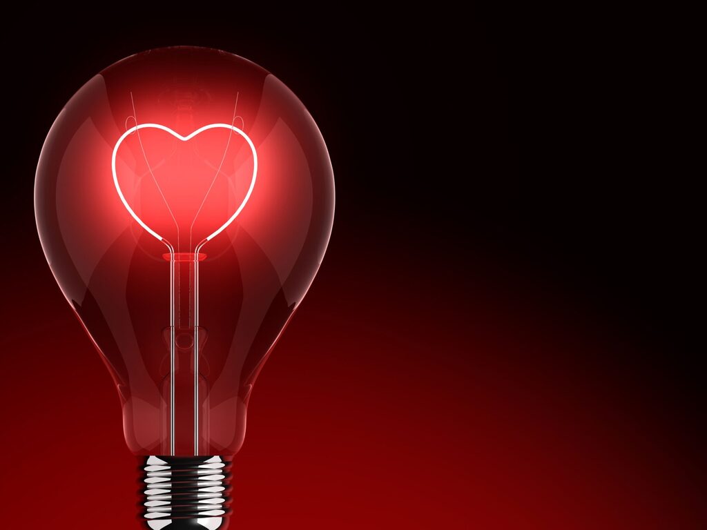 day use hotel for couples: A red light bulb with a heart-shaped filament