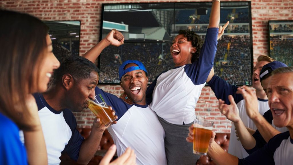 game day sports grille: fans cheering on their sports team at eatery