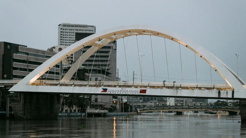 big white arch road bridge over the Pasig River linking Binondo and Intramuros in Manila.