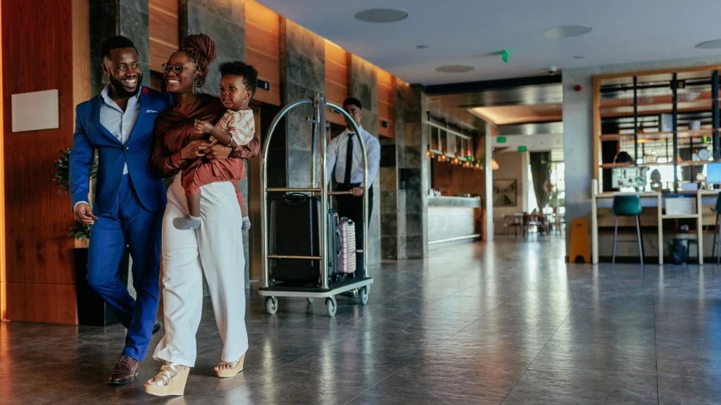 overnight stays with hotelsbyday: family on vacation walking in hotel lobby