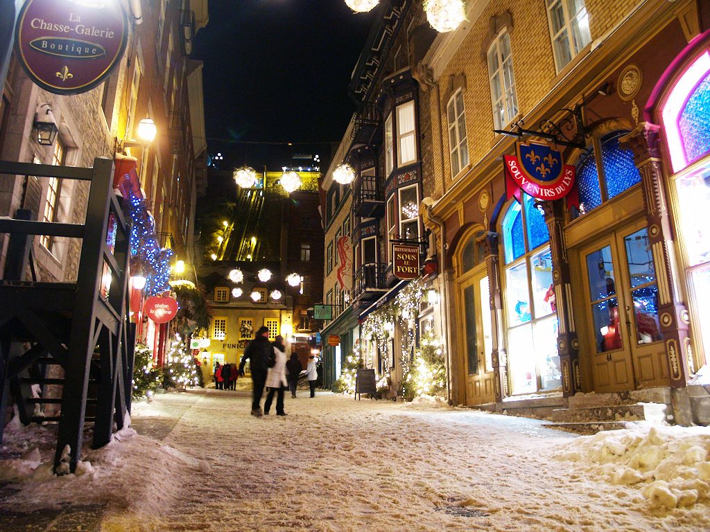 Petit Champlain in Quebec City on snowy holiday evening.