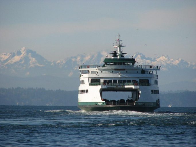 Ferry cruising the Washington Sound with snow-capped mountains in background.