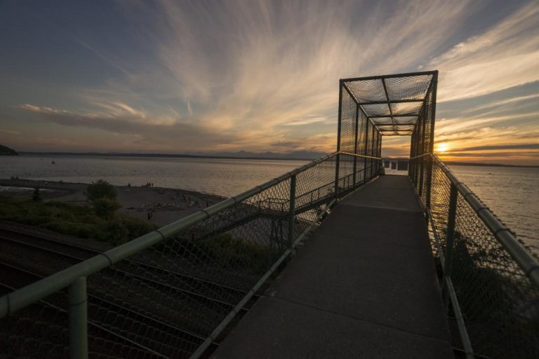 A creamsicle sky looking out from the pedestrian bridge at Carkeek Park in Seattle.