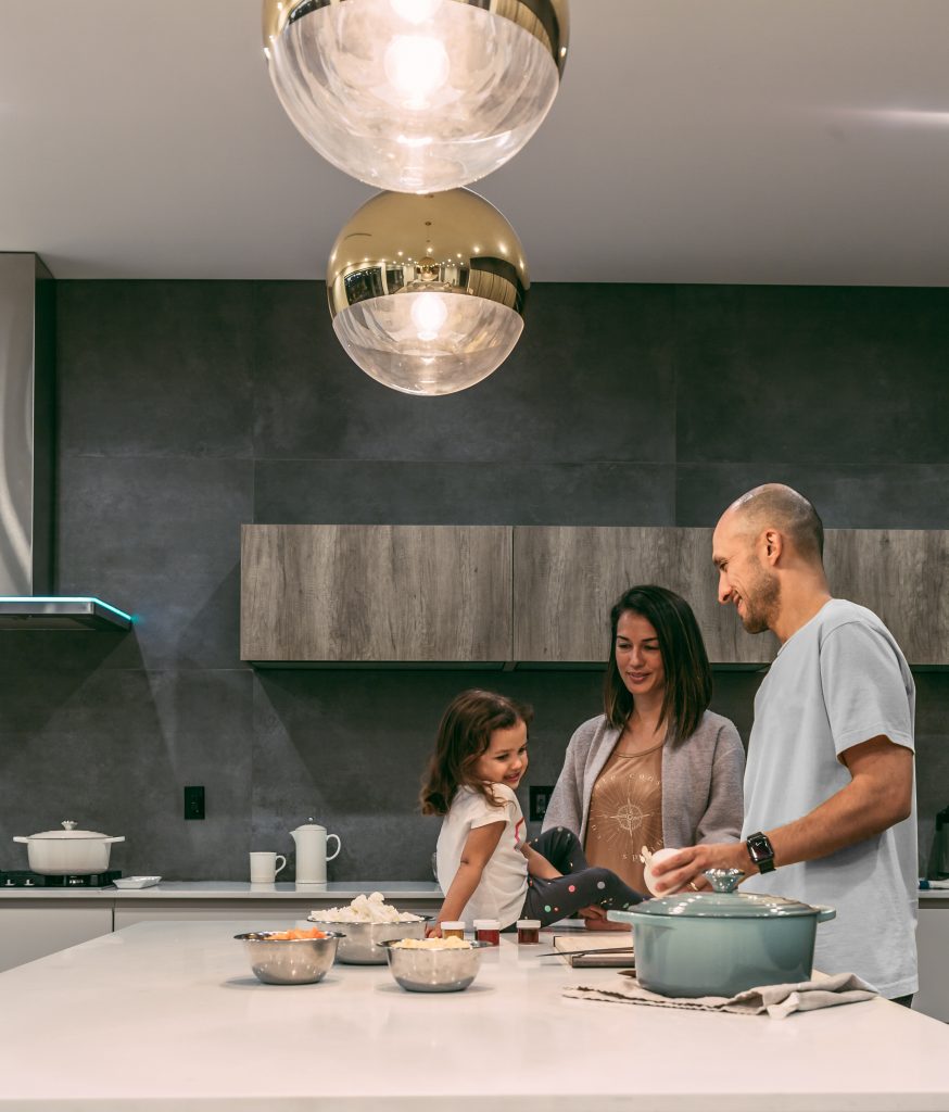 Father and daughter cooking for mom in the kitchen.