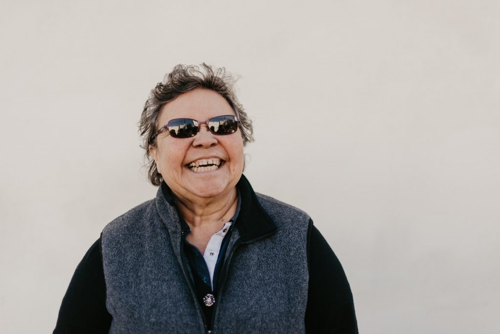 Mother smiling wide from receiving a thoughtful Mother's Day Gift.